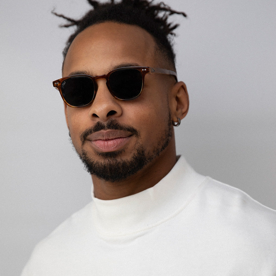 Black man wearing small red frame sunglasses