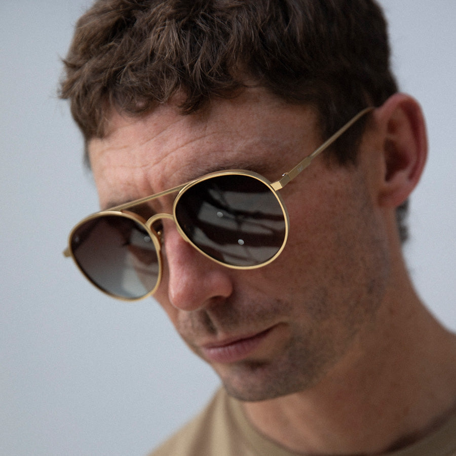 Man looking down wearing large aviator sunglasses with polarised lenses