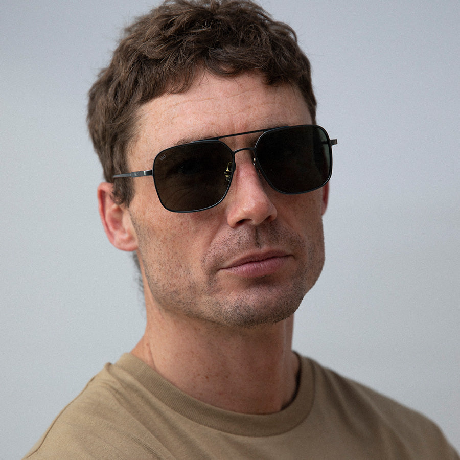 Man wearing large square metal sunglasses 