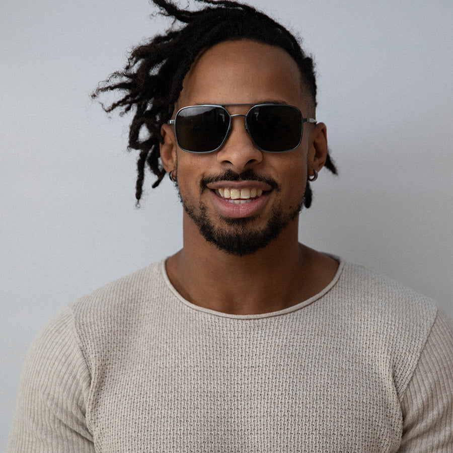 Black man wearing large square metal sunglasses 