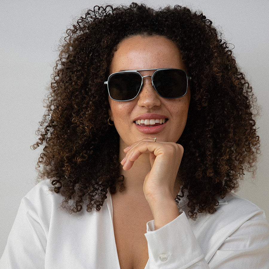 Black woman wearing large square metal sunglasses 