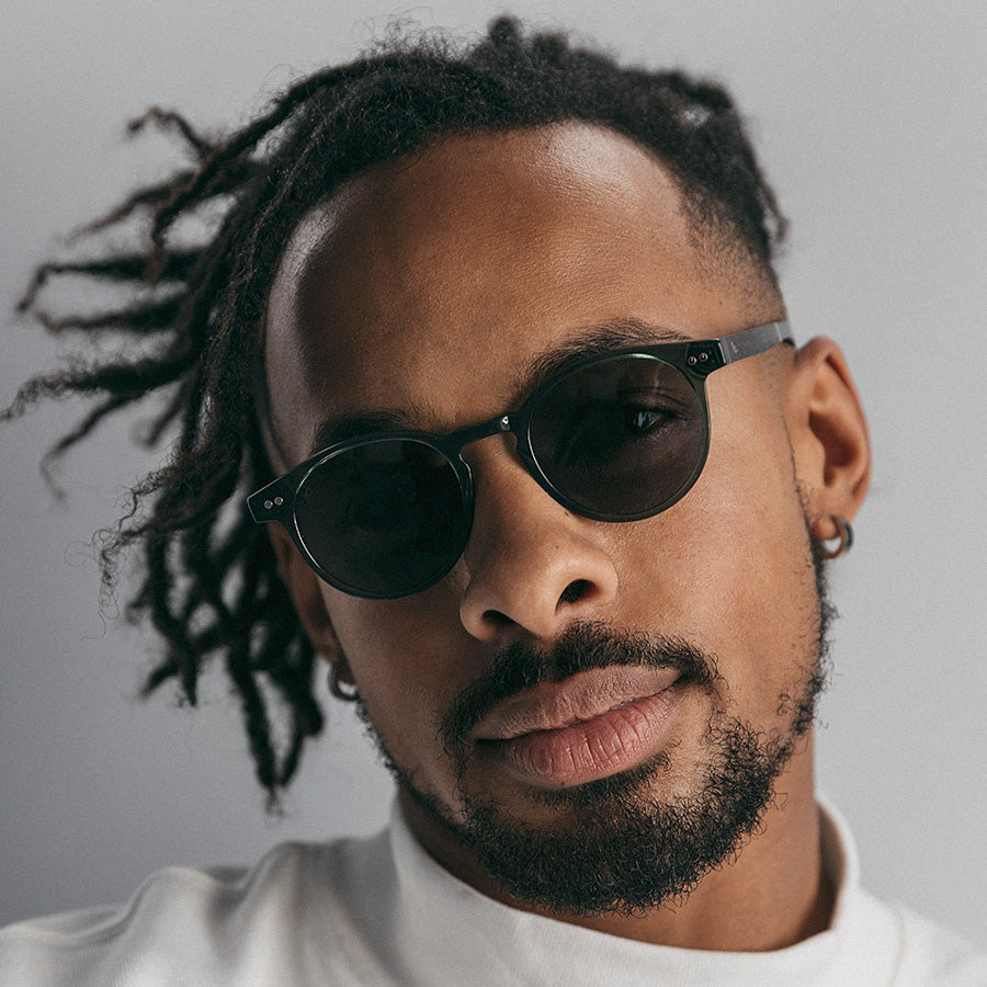 Black man wearing olive green sunglasses 